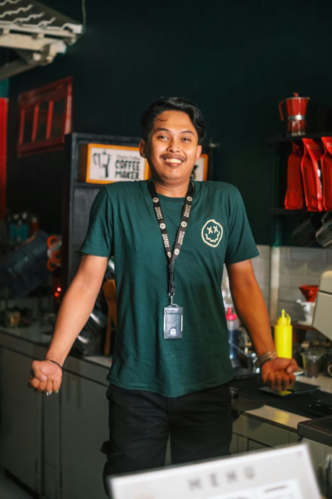 a man standing in a kitchen next to a washing machine